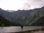 Marty in front of Avalanche Lake and mountains with waterfalls